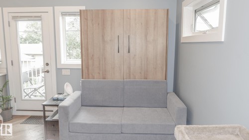 Integrated wall unit with wood-finish cabinetry and modern hardware - 11131 52 Street, Edmonton, AB - Indoor Photo Showing Other Room