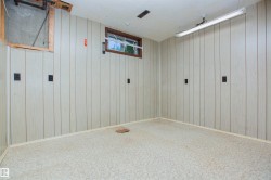 Vertical wood-look paneling walls with light-toned linoleum flooring - 