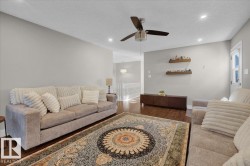 Living room featuring a textured ceiling, dark wood finished floors, recessed lighting, and a ceiling fan - 
