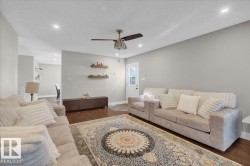 Living room featuring wood finished floors, recessed lighting, a textured ceiling, and a ceiling fan - 