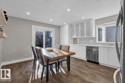 Dining area with a textured ceiling, recessed lighting, and dark wood-style floors - 