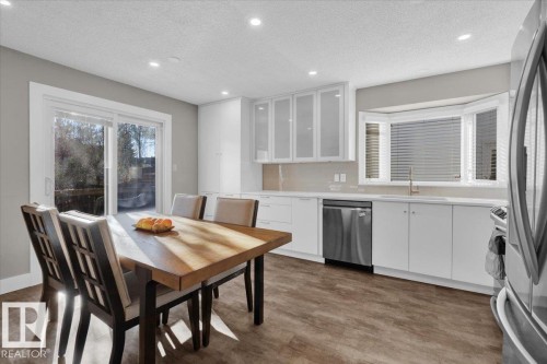 Kitchen featuring white cabinets, a textured ceiling, glass insert cabinets, stainless steel appliances, and recessed lighting - 3515 20 Avenue, Edmonton, AB - Indoor