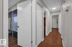 Hallway with dark wood-type flooring and a textured ceiling - 