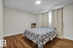 Bedroom featuring a textured ceiling and wood finished floors - 