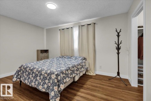 Bedroom with a textured ceiling and dark wood finished floors - 3515 20 Avenue, Edmonton, AB - Indoor Photo Showing Bedroom