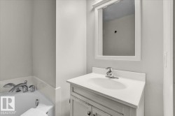 Full bathroom featuring vanity and a garden tub - 
