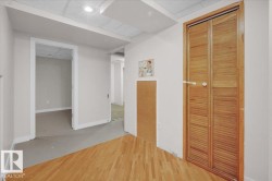 Corridor with wood finished floors and a drop ceiling - 
