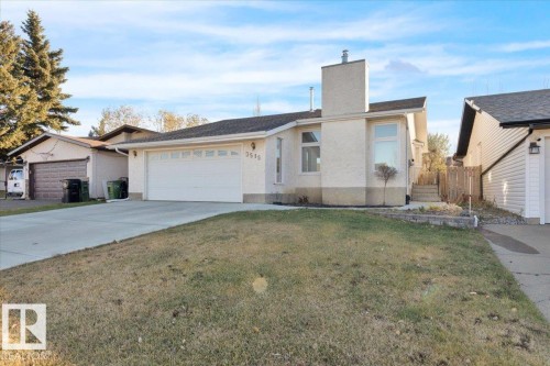 Single story home with a chimney, a front yard, concrete driveway, and a garage - 3515 20 Avenue, Edmonton, AB - Outdoor