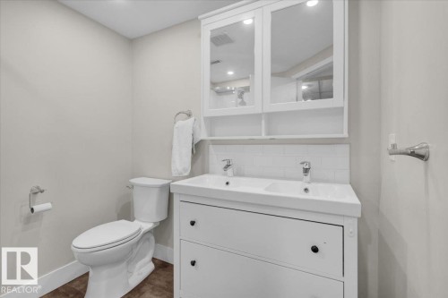 Bathroom featuring tasteful backsplash, double vanity, and dark tile patterned flooring - 3515 20 Avenue, Edmonton, AB - Indoor Photo Showing Bathroom