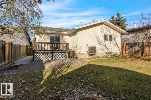 Rear view of property with a fenced backyard, a deck, and stucco siding - 3515 20 Avenue, Edmonton, AB - Outdoor With Deck Patio Veranda