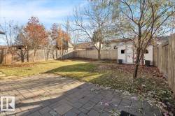Fenced backyard featuring an outbuilding - 