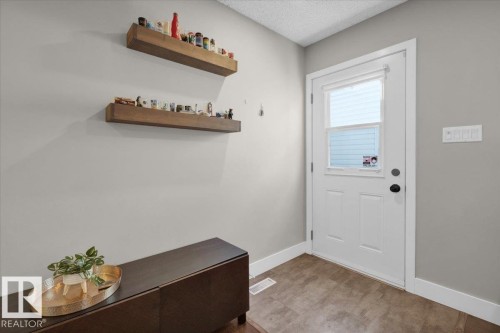 Doorway to outside with baseboards and a textured ceiling - 3515 20 Avenue, Edmonton, AB - Indoor Photo Showing Other Room