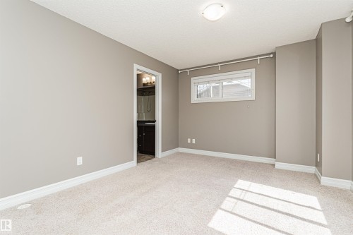 Carpeted room with neutral wall tones and white baseboards - 110 3625 144 Avenue, Edmonton, AB - Indoor Photo Showing Other Room