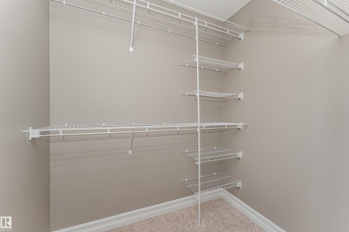 Walk-in closet featuring wire shelving and hanging rods - 110 3625 144 Avenue, Edmonton, AB - Indoor With Storage