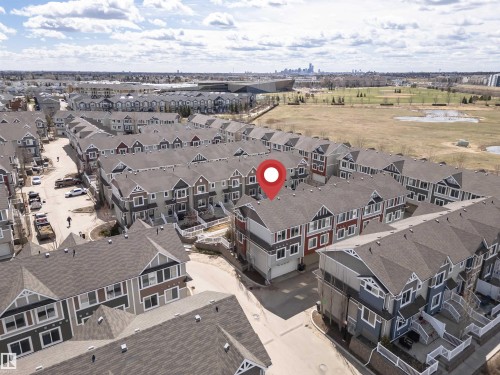 Townhome community featuring multi-story units with varying facade colors and gabled roofs - 110 3625 144 Avenue, Edmonton, AB - Outdoor With View