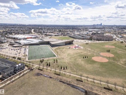 Aerial perspective showcasing a large sports complex with an artificial turf field, multiple baseball diamonds, and a recreational park area - 110 3625 144 Avenue, Edmonton, AB - Outdoor With View