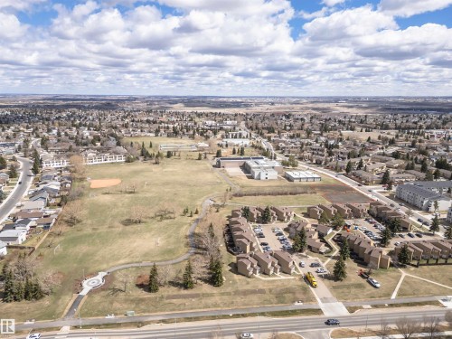 Expansive neighborhood featuring a mix of residential structures and open green spaces - 110 3625 144 Avenue, Edmonton, AB - Outdoor With View