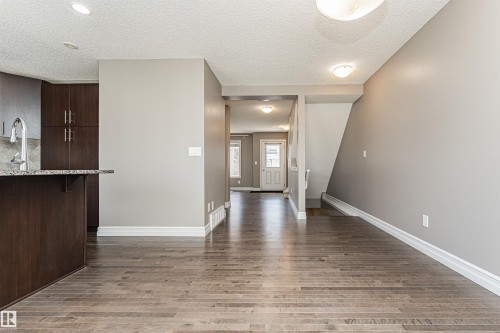 Open concept living area with wood-finish flooring - 110 3625 144 Avenue, Edmonton, AB - Indoor