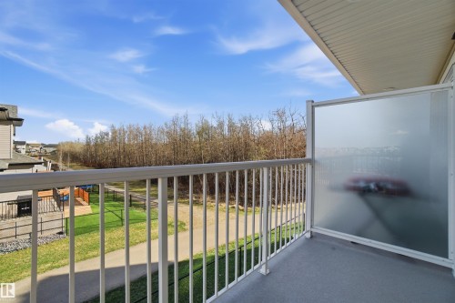Private balcony with a textured concrete surface and white metal railings - 64 17832 78 Street, Edmonton, AB - Outdoor With Balcony With Exterior