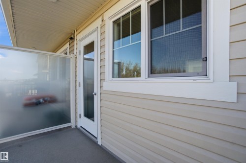 Exterior balcony with a frosted glass partition and a full-light door - 64 17832 78 Street, Edmonton, AB - Outdoor With Exterior