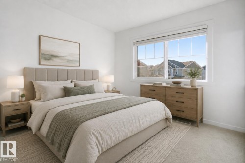 Bedroom featuring a large window, light-colored walls, and carpeting - 64 17832 78 Street, Edmonton, AB - Indoor Photo Showing Bedroom