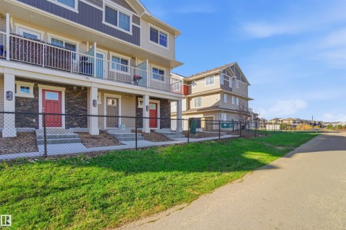 Modern townhome row featuring a blend of horizontal siding and stone veneer - 64 17832 78 Street, Edmonton, AB - Outdoor With Balcony