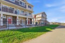 Modern townhome row featuring a blend of horizontal siding and stone veneer - 64 17832 78 Street, Edmonton, AB  - Outdoor With Balcony 