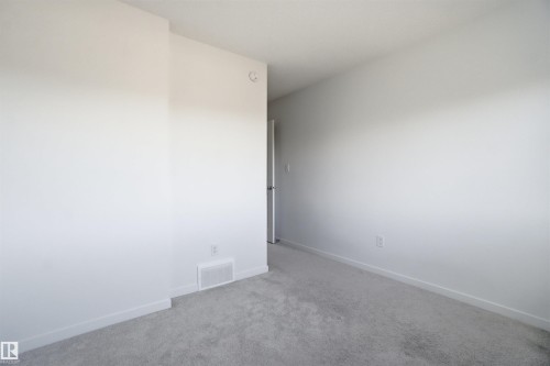 Interior room featuring light gray wall paint, light gray carpeting, and white baseboards - 64 17832 78 Street, Edmonton, AB - Indoor Photo Showing Other Room