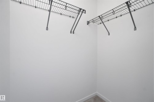 White-painted closet featuring wire shelving and carpet flooring - 64 17832 78 Street, Edmonton, AB - Indoor
