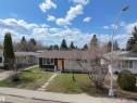 Single-story residence featuring a dark facade with stone accents and a contrasting red and yellow entry - 3912 108 Street, Edmonton, AB  - Outdoor 