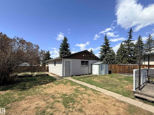 Detached garage featuring horizontal siding and a side entry door - 3912 108 Street, Edmonton, AB - Outdoor