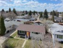 Split-level residence featuring a brown shingle roof, light-colored siding, and a contrasting dark-paneled section - 3912 108 Street, Edmonton, AB  - Outdoor 