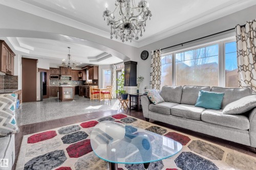 Open-concept living space with hardwood flooring and a large window - 10915 175 Avenue, Edmonton, AB - Indoor Photo Showing Living Room