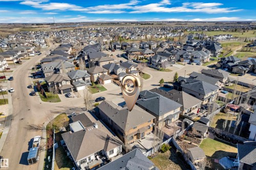 Aerial perspective showcasing a residential neighborhood with numerous single-family homes, paved roads, and fenced backyards - 10915 175 Avenue, Edmonton, AB - Outdoor With View