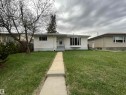 Single-story residence featuring white horizontal siding, a gray concrete walkway, and a front yard with established trees - 13804 132 Avenue, Edmonton, AB  - Outdoor 