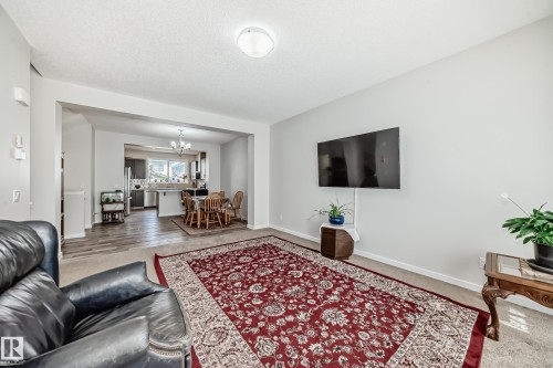 Open-concept living area featuring light neutral wall tones and carpet flooring - 4609 Alwood Way, Edmonton, AB - Indoor Photo Showing Living Room