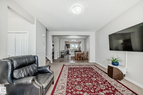 Bright main living area featuring carpet flooring and light-toned walls - 4609 Alwood Way, Edmonton, AB - Indoor Photo Showing Living Room