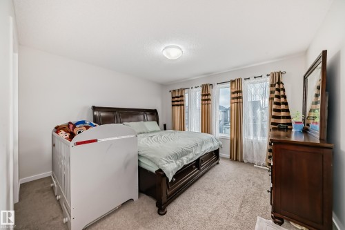 Bright bedroom featuring soft neutral wall tones and plush carpet flooring - 4609 Alwood Way, Edmonton, AB - Indoor Photo Showing Bedroom