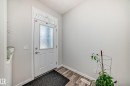 Entryway with a white paneled door featuring a privacy glass insert and transom window - 4609 Alwood Way, Edmonton, AB  - Indoor Photo Showing Other Room 