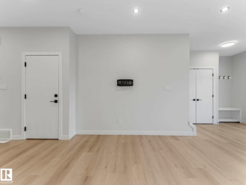 Light wood-finish flooring complements the neutral wall tones - 15731 109 Avenue, Edmonton, AB - Indoor Photo Showing Other Room