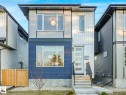 Contemporary facade featuring mixed siding materials, large format windows, a modern entryway, and a concrete pathway with steps - 15731 109 Avenue, Edmonton, AB  - Outdoor 