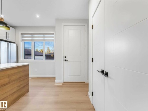 Modern white interior doors with black hardware - 15731 109 Avenue, Edmonton, AB - Indoor Photo Showing Other Room