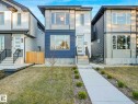 Contemporary facade featuring a prominent entry with a glass-paneled door, dual-tone horizontal siding, and large picture windows - 15731 109 Avenue, Edmonton, AB  - Outdoor 