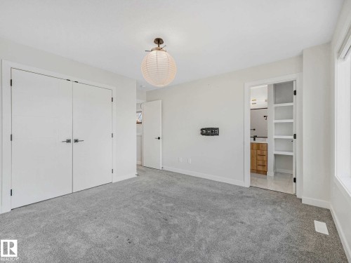 Light gray carpeting with bright white walls - 15731 109 Avenue, Edmonton, AB - Indoor Photo Showing Other Room