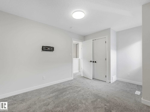 Plush grey carpeting and neutral wall tones - 15731 109 Avenue, Edmonton, AB - Indoor Photo Showing Other Room