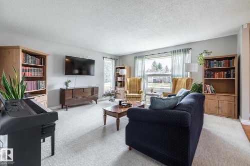 Bright living space featuring light gray wall paint and a textured ceiling - 3608 16A Avenue, Edmonton, AB - Indoor Photo Showing Living Room