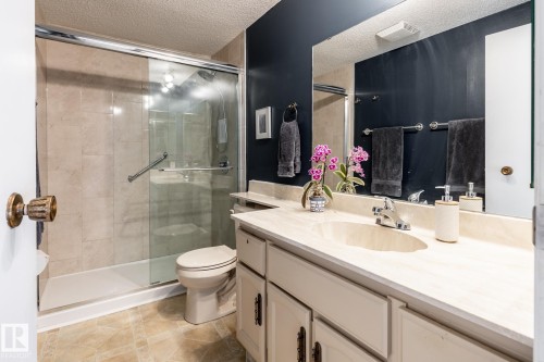 Bathroom vanity with integrated sink, chrome faucet, and expansive wall mirror - 3608 16A Avenue, Edmonton, AB - Indoor Photo Showing Bathroom