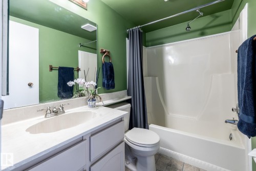 Bathroom featuring a vanity with an integrated sink, polished chrome faucet, and a large wall-mounted mirror - 3608 16A Avenue, Edmonton, AB - Indoor Photo Showing Bathroom