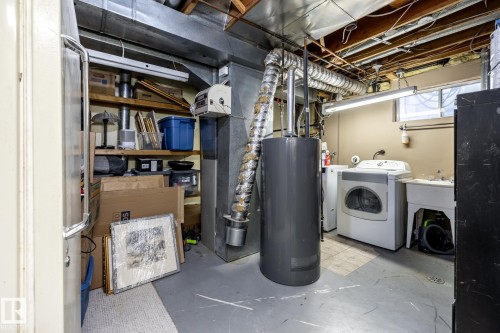 Utility room featuring a laundry area with a wash tub, fluorescent lighting, and a window - 3608 16A Avenue, Edmonton, AB - Indoor Photo Showing Laundry Room