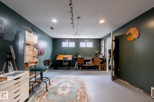 Versatile room featuring dark green walls, recessed lighting, and track lighting - 3608 16A Avenue, Edmonton, AB - Indoor
